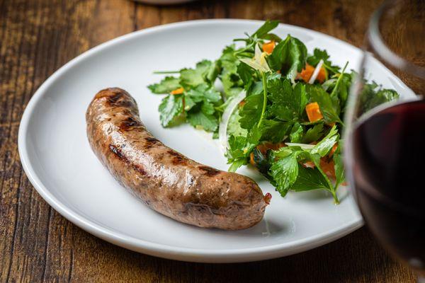 Pork sausage with roasted sweet potato and parsley salad