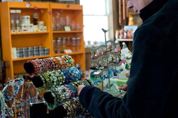 A shopper perusing Nabos' wide variety of jewelry.