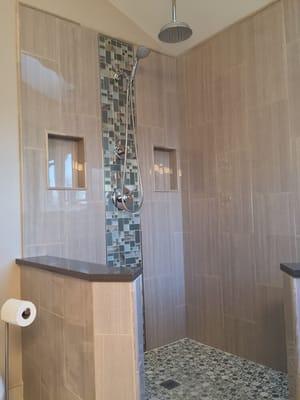 Bathroom remodel with walk in shower. Complete with rain shower head, personal shower and his/her niches.