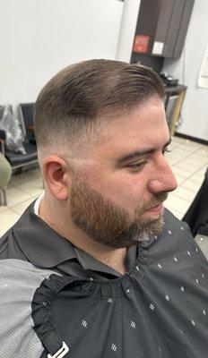 Mid skin fade with beard trim.