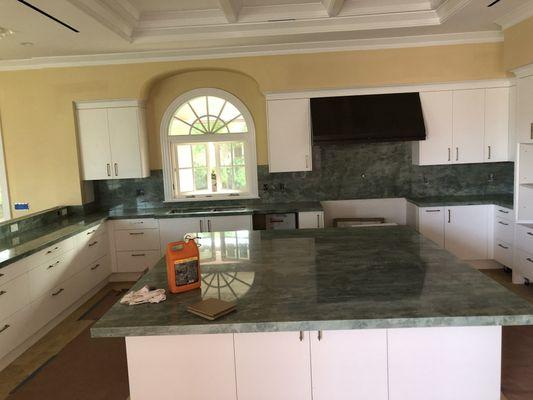 Kitchen countertops with full high backsplash.