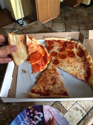 What's in this photo? A NON WELL DONE PIZZA.