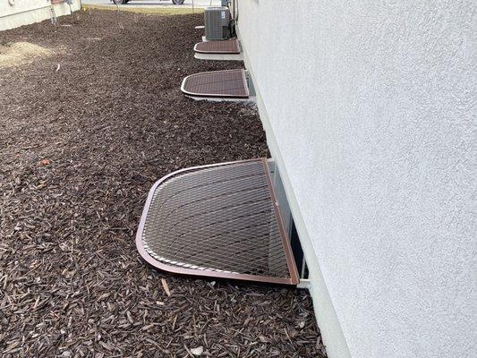 Three wells covered with mesh grates