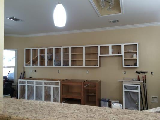 Tore out all old cabinets, added 8 more feet of cabinets, boxed light removed for a fixture, Prior picture is included