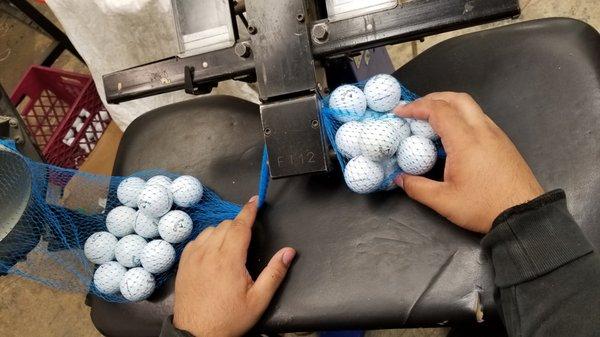 Packaging our golf balls into manageable bundles.