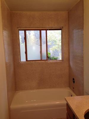 After: Mutli-color finish on tile and classic white tub