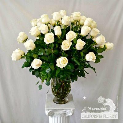 Four 4 dozen beautiful long stem white roses in clear vase. Stunning!