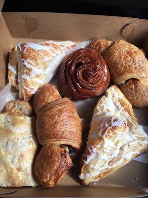 Delicious pastries! Apple turnovers, chocolate croissants, plain sticky bun, and a slice of apple strudel