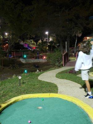 Mini golf at night, color lights.