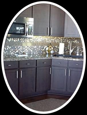 Terra Ombra Countertops; Crown Mix Mosaic on the backsplash, inlaid with granite.  Chocolate Pear cabinets.