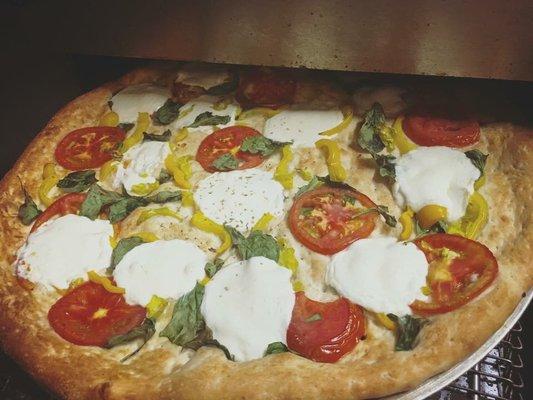 Primavera Pizza with fresh mozzarella Fresh Tomatoes pepperocini  and spinach