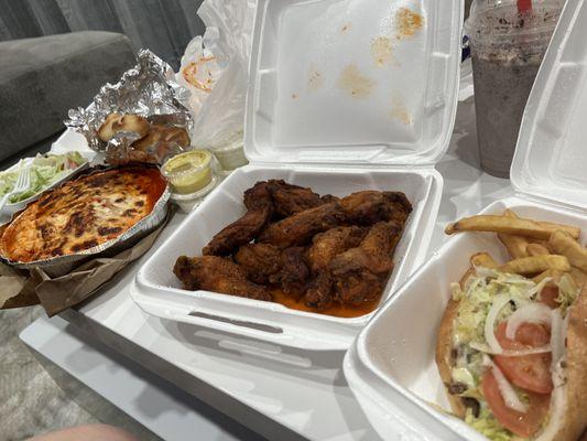 buffalo wings , steak & cheese with a lasagna on the side