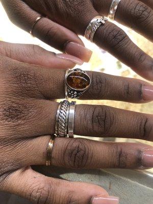 picture: purchased cross and plain band on my left ring finger and 3 layered ring with the spinning center on my right middle finger