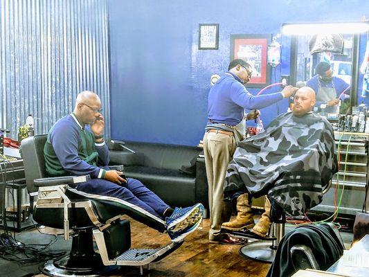 Barber working, Client waiting