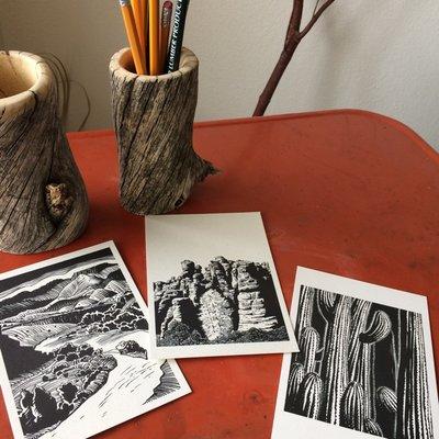 Pinon Pine Pencil Canisters made from local wood and a selection of artist postcards.