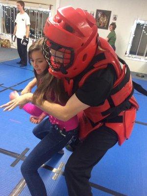 Master Joe and a young student learning an escape technique in an abduction scenario during a women's self defense class.