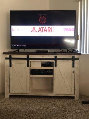 Custom 60" TV stand with sliding barn style doors - shabby white bottom with black hardware and dark wood top