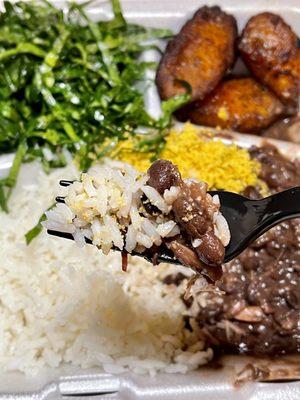 Feijoada - meat and bean stew, white rice, fresh kale in background