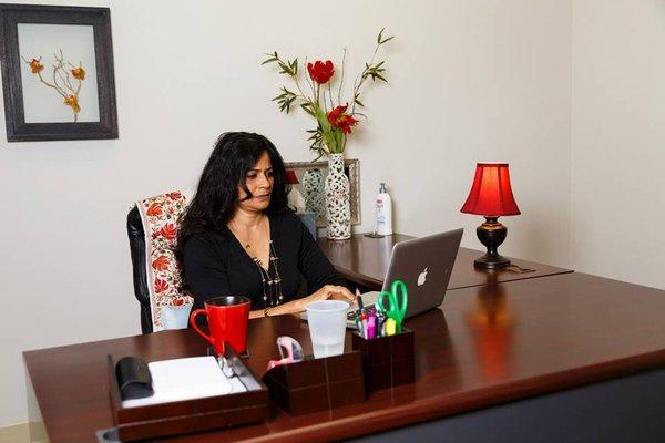 Minu Prasad, our design specialist at GMR Web Team working at her desk.