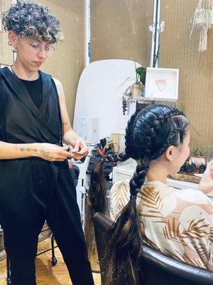 Stylist Kylie working her braiding magic after a "keep me healthy and braided" service