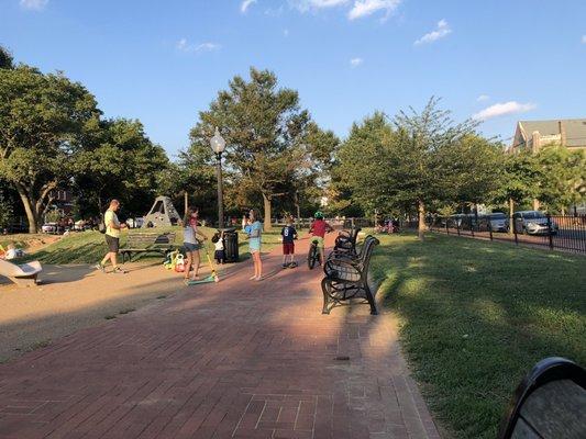 A brick path goes around the park