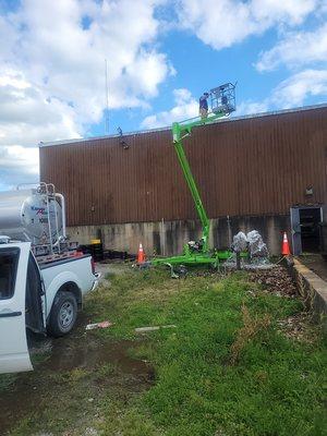 Lift used to pressure wash roof and drains