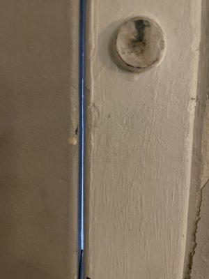 The blue light is the air gap in the door frame where cold air pours in.