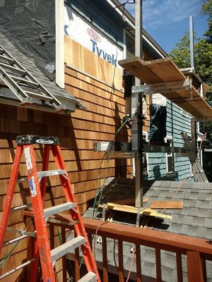 New trim and cedar shake siding to repair ice dam damages in Billerica, MA.