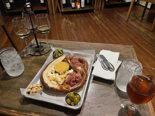 Beer cheese pretzel charcuterie board, ancient city orange beer and a white classic wine flight and water: