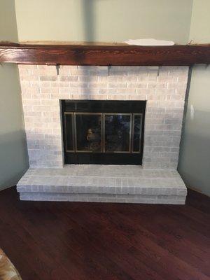 Whitewashed fireplace stained mantle