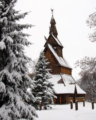 A winter photograph of the Moorhead Stave Church, or the Hopperstad Stave Church replica.