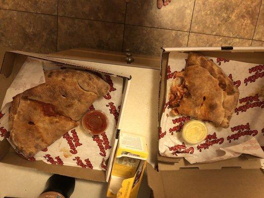 Calzone on left intact. Calzone on right missing the other half. Where did it go? It was ripped off and is missing.