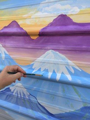 Closeup of scenic mural painted for family on wall of their backyard shed