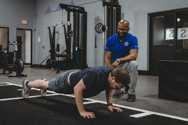 Tim Collins is coaching his client of 10 years through a comprehensive strength training session!