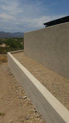 4 ft tall retaining wall with a 6 ft tall wall behind that.