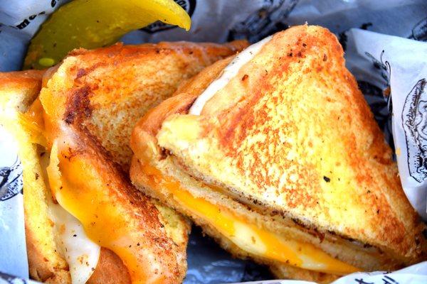 This is Not Yo Mommas Grilled Cheese! Buttery grilled Texas toast bonded by provolone and Colby cheese triple stacked.