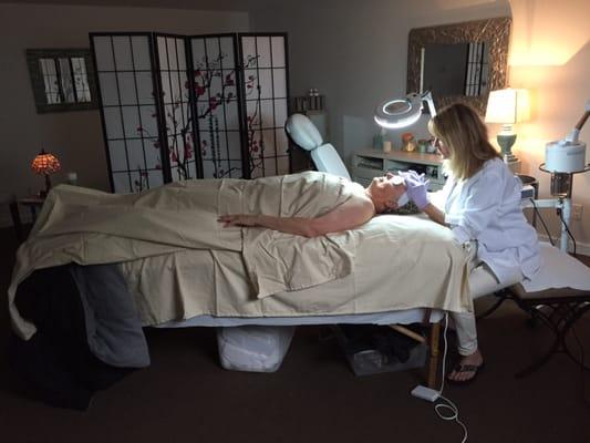 A client receives a face peel treatment.