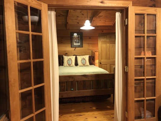 French doors to the bedroom from the sunroom, directly across from the wood burning stove