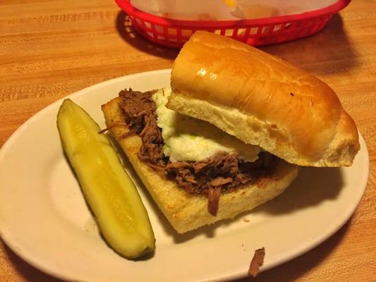 Roast beef sandwich with Slaw and a pickle on the side