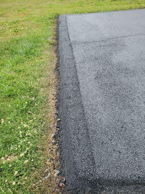 Repaired edge where grass was growing thru.