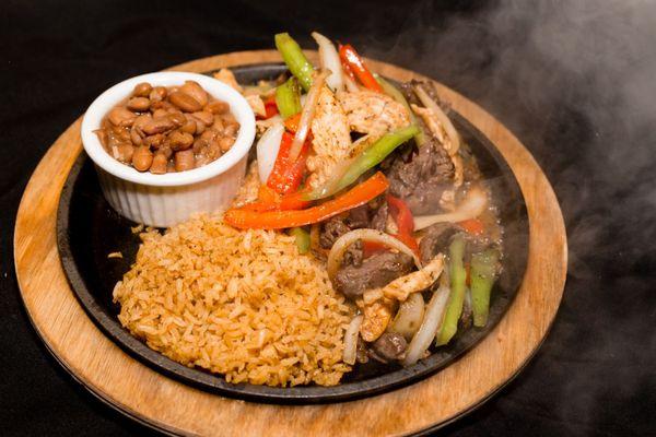 Steaming hot fajitas with rice and beans