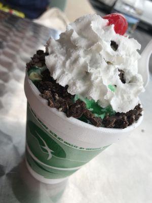 Vanilla ice cream with creme de menthe, Andes chocolate chunks, cookie crumbles, whipped topping, and a cherry. Yum!