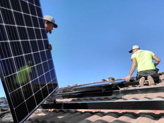 Solar Panels Being Installed On Roof