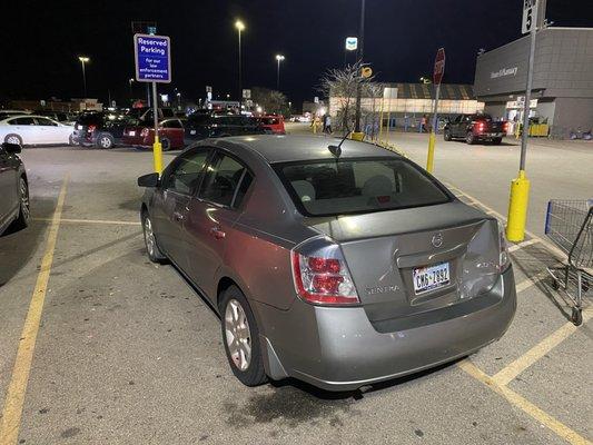 A Walmart employees car parked in a reserved spot for police officers