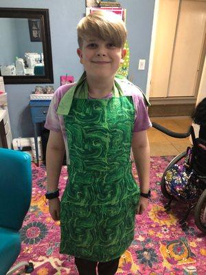 Conner in his new apron sewn at Camp Giggle Stitch classes