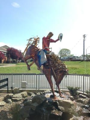 Animated cowboy metal sculpture in front of McD's.