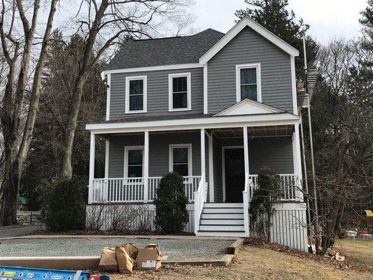 New siding/trim, extended front porch roof, and new decking and railings