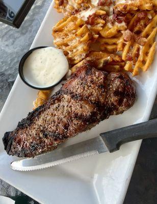 NY strip with loaded waffle fries.