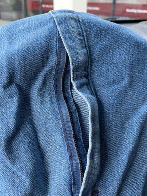 Broken zipper on overalls.