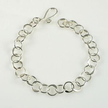 This handcrafted Sterling Silver bracelet features 30 - 5.5mm 18 gauge circles and works great for a charm bracelet.